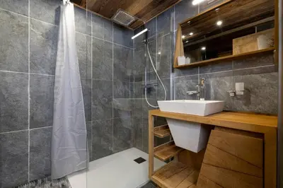 a bathroom with a shower and a white sink at Momi Cocon 4pax Jardin Jacuzzi Vue in Chamonix-Mont-Blanc