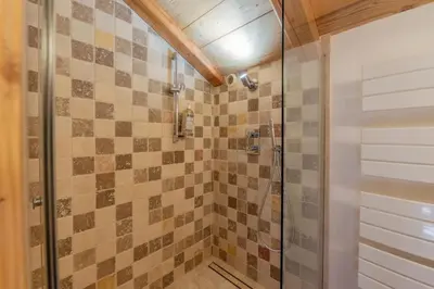 a bathroom with a shower with a glass door at Lays Mazot Calme Vues Parking in Saint-Gervais-les-Bains
