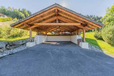 a pavilion with a wooden roof on a driveway at Lays Mazot Calme Vues Parking in Saint-Gervais-les-Bains