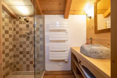 a bathroom with a sink and a glass shower at Lays Mazot Calme Vues Parking in Saint-Gervais-les-Bains