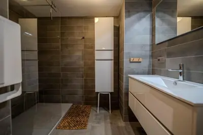 a bathroom with a tub and a sink at Vieil Ours Douillet Chalet 11pax Familial Vue in Chamonix-Mont-Blanc