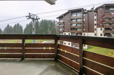 a view from the balcony of a house with a wooden fence at Le Repos du Skieur - Au pied des pistes in Morillon
