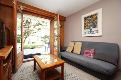 a living room with a couch and a glass table at Appartement 2 pers hyper centre Chamonix in Chamonix-Mont-Blanc