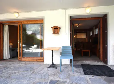 a blue chair sitting in front of a building at Appartement 2 pers hyper centre Chamonix in Chamonix-Mont-Blanc