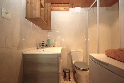 a small bathroom with a sink and a toilet at Appartement 2 pers hyper centre Chamonix in Chamonix-Mont-Blanc