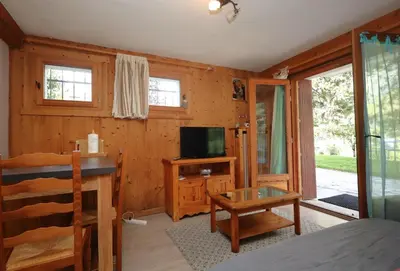 a bedroom with a bed and a tv and a table at Appartement 2 pers hyper centre Chamonix in Chamonix-Mont-Blanc