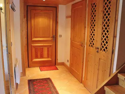 a hallway with a door and a rug next to a room at Charmant duplex 7 pers à Samoëns avec piscine et Wi-Fi - FR-1-815-46 in Samoëns