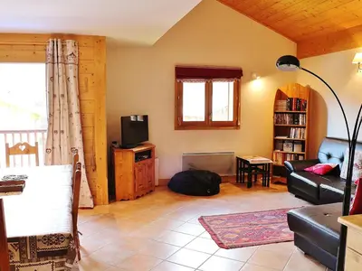 a living room with a couch and a tv at Charmant duplex 7 pers à Samoëns avec piscine et Wi-Fi - FR-1-815-46 in Samoëns
