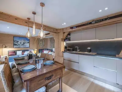 a kitchen and living room with a wooden table at Duplex au pied de la télécabine à Megève - 4 chambres - FR-1-569-204 in Megève