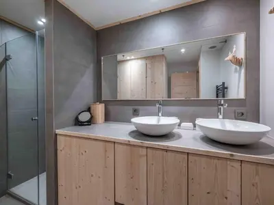 a bathroom with two sinks and a mirror at Duplex au pied de la télécabine à Megève - 4 chambres - FR-1-569-204 in Megève
