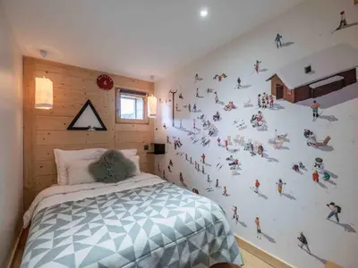 a bedroom with a wall with people on it at Duplex au pied de la télécabine à Megève - 4 chambres - FR-1-569-204 in Megève