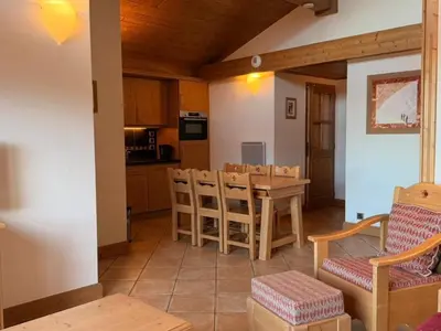 a kitchen and dining room with a table and chairs at Appartement cosy 3 pièces près des pistes avec parking - FR-1-572-344 in Arâches-la-Frasse