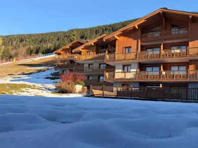 a lodge in the snow with a lot of snow at Appartement cosy 3 pièces près des pistes avec parking - FR-1-572-344 in Arâches-la-Frasse