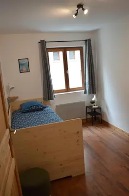 a bedroom with a bed and a window at Appartement aux portes de St Gervais in Saint-Gervais-les-Bains