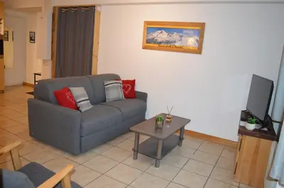 a living room with a couch and a table at Appartement aux portes de St Gervais in Saint-Gervais-les-Bains