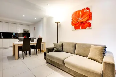 a living room with a couch and a table at Grand Paradis B11 - Good location & parking in Chamonix-Mont-Blanc