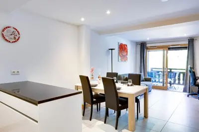 a kitchen and dining room with a table and chairs at Grand Paradis B11 - Good location & parking in Chamonix-Mont-Blanc