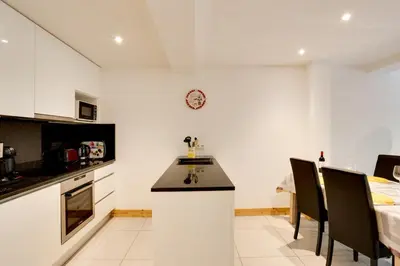 a kitchen with a counter and a dining room at Grand Paradis B11 - Good location & parking in Chamonix-Mont-Blanc