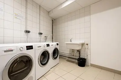 a laundry room with a washing machine and a sink at Grand Paradis B11 - Good location & parking in Chamonix-Mont-Blanc