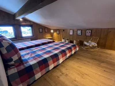 a bedroom with a large bed in a room at Megève 105 m2 ensoleillé rénové au pied des pistes in Megève