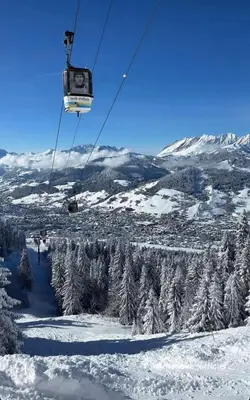 a ski lift going up a snow covered mountain at Megève 105 m2 ensoleillé rénové au pied des pistes in Megève