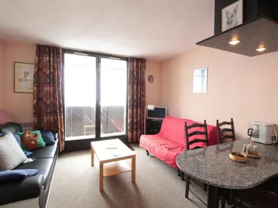 a living room with a red couch and a table at Studio en montagne pour 4 pers, balcon sud, animaux admis - FR-1-687-121 in Arâches-la-Frasse