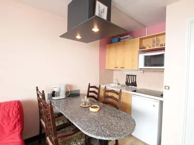 a living room with a red couch and a large window at Studio en montagne pour 4 pers, balcon sud, animaux admis - FR-1-687-121 in Arâches-la-Frasse