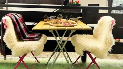 two white chairs with a table with food on it at Melba Megeve emplacement de rêve dans le village au calme in Megève