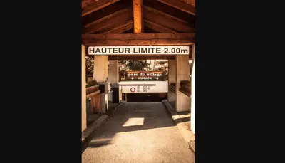 a car parked in a garage with a sign on it at Melba Megeve emplacement de rêve dans le village au calme in Megève