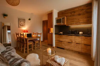 a living room with a kitchen and a dining room at Melba Megeve emplacement de rêve dans le village au calme in Megève
