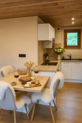 a kitchen with a table with a plate of food at Sapins blancs Megeve in Megève
