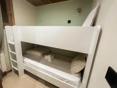 a white bunk bed with two pillows in a room at Sapins blancs Megeve in Megève