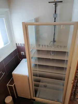 a shower with a glass door in a bathroom at Apparement cosy 4 personnes in Samoëns