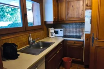 a kitchen with a sink and a microwave at Stay in an ideal mountain chalet! in Megève