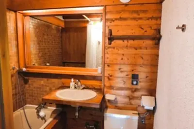 a bathroom with a sink and a mirror at Stay in an ideal mountain chalet! in Megève