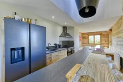 a large kitchen with a large steel refrigerator at Bright chalet in Combloux close to the slopes in Combloux