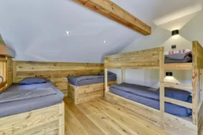 a room with bunk beds in a cabin at Bright chalet in Combloux close to the slopes in Combloux