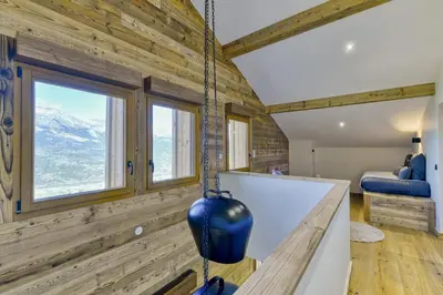 a room with wooden walls and a large window at Bright chalet in Combloux close to the slopes in Combloux