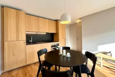 a dining room with a black table and chairs at Bright apartment with terrace in Megève in Megève
