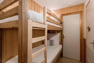 a bunk bed room with two bunk beds in a cabin at Le Cocon du Prarion in Les Houches