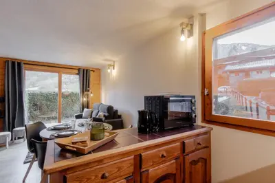 an office with a desk with a microwave and a window at Le Cocon du Prarion in Les Houches