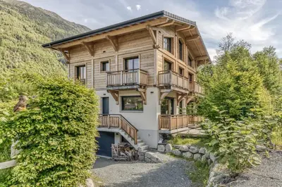 a house in the mountains with a balcony at Chalet 18 guests, 8 bedrooms, 5 bathrooms & Sauna! in Les Houches