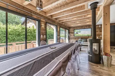 a large bed in a room with windows at Chalet 18 guests, 8 bedrooms, 5 bathrooms & Sauna! in Les Houches