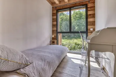 a bedroom with a bed and a window and a piano at Chalet 18 guests, 8 bedrooms, 5 bathrooms & Sauna! in Les Houches