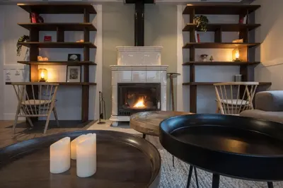 a living room with a fireplace and a table with candles at Chalet 7CH Groupes Centre-ville Sauna in Chamonix-Mont-Blanc