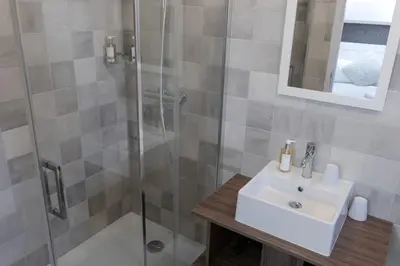 a bathroom with a sink and a shower at Chalet 7CH Groupes Centre-ville Sauna in Chamonix-Mont-Blanc