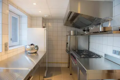 a kitchen with a stove and a counter top at Chalet 7CH Groupes Centre-ville Sauna in Chamonix-Mont-Blanc