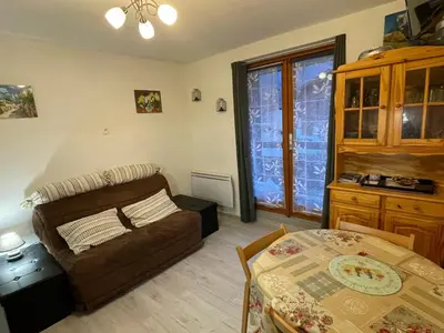 a living room with a couch and a table at Studio cosy au centre de Samoëns pour 4 pers, animaux admis - FR-1-629-153 in Samoëns