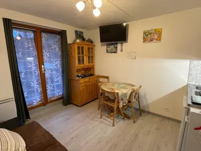 a small room with a table and a kitchen at Studio cosy au centre de Samoëns pour 4 pers, animaux admis - FR-1-629-153 in Samoëns