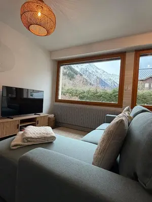 a building in the snow with mountains in the background at Chalet d'Honneur in Chamonix-Mont-Blanc